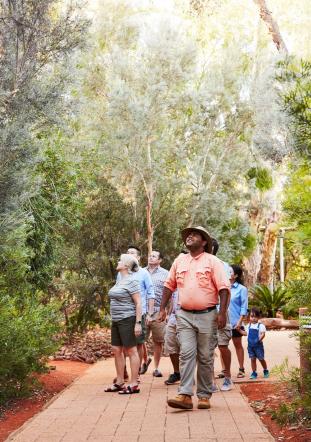 Group taking guided tour of gardens at Ayers Rock Resort